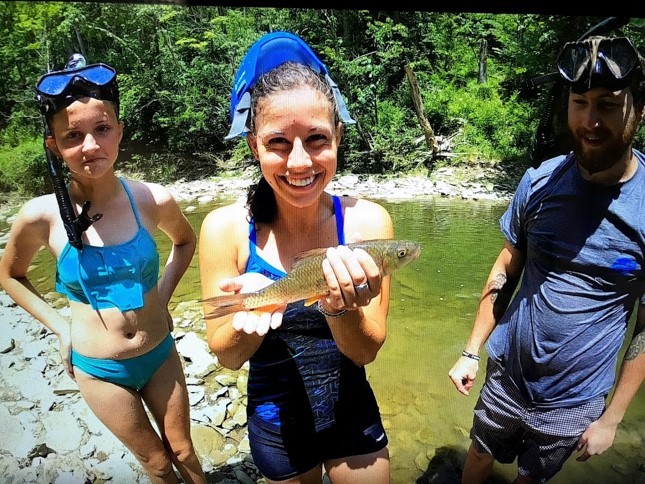 girl holding sucker fish